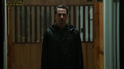 Matthew Rhys as Tom Loflis wearing a raincoat in Widow's Bay