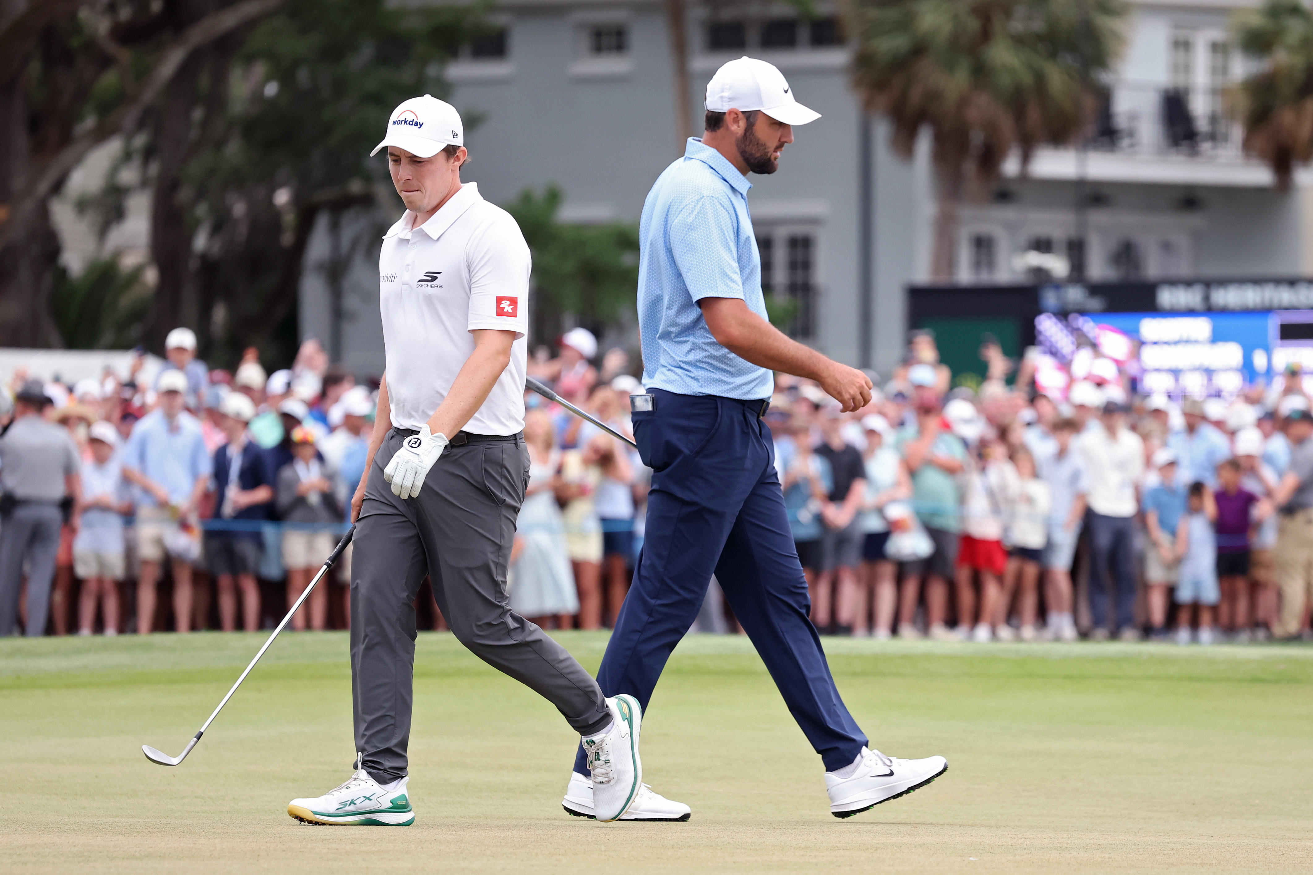 Matt Fitzpatrick (left) and Scottie Scheffler walk past each other on the 18th green at the 2026 RBC Heritage
