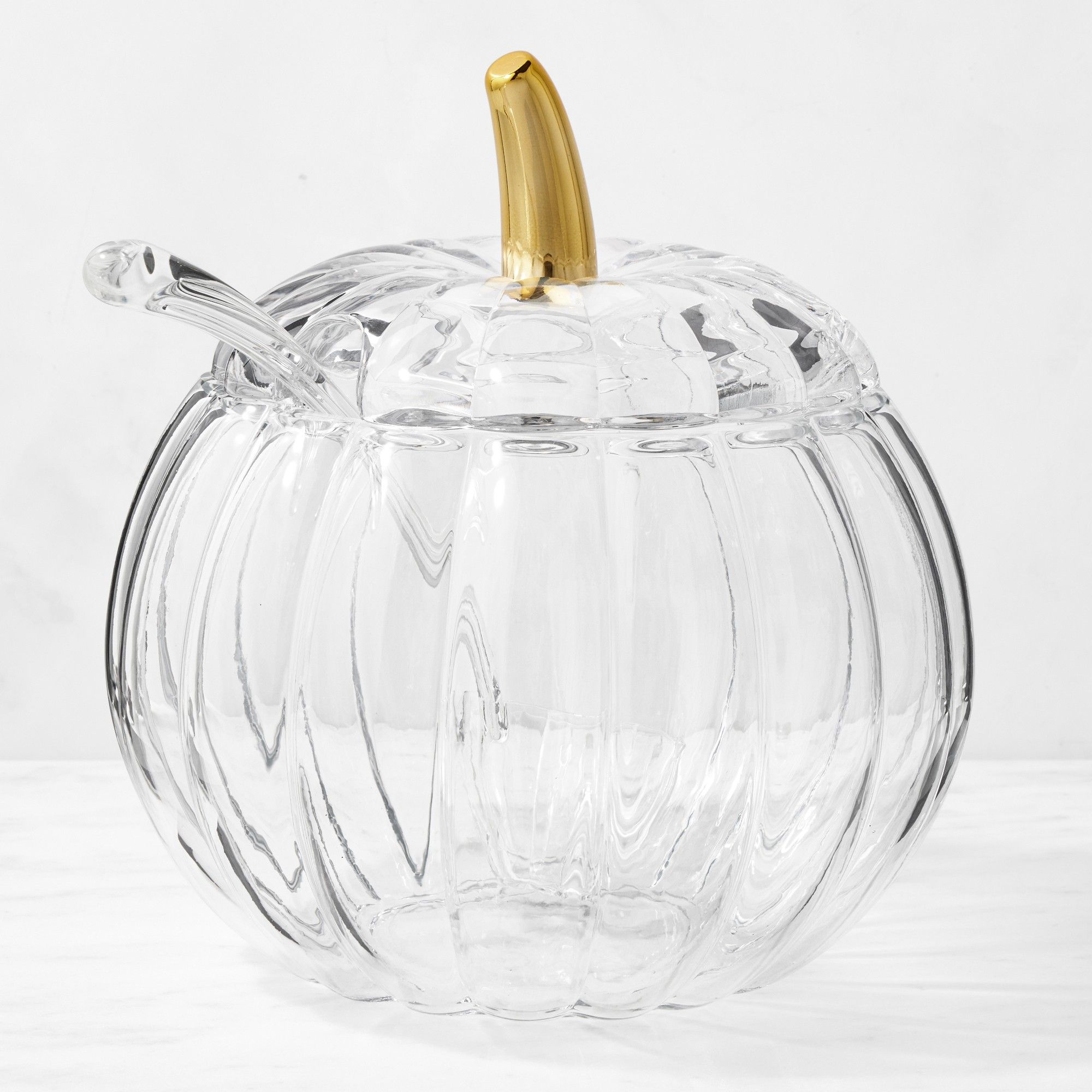 Glass pumpkin-shaped punch bowl with matching ladle and gold stem
