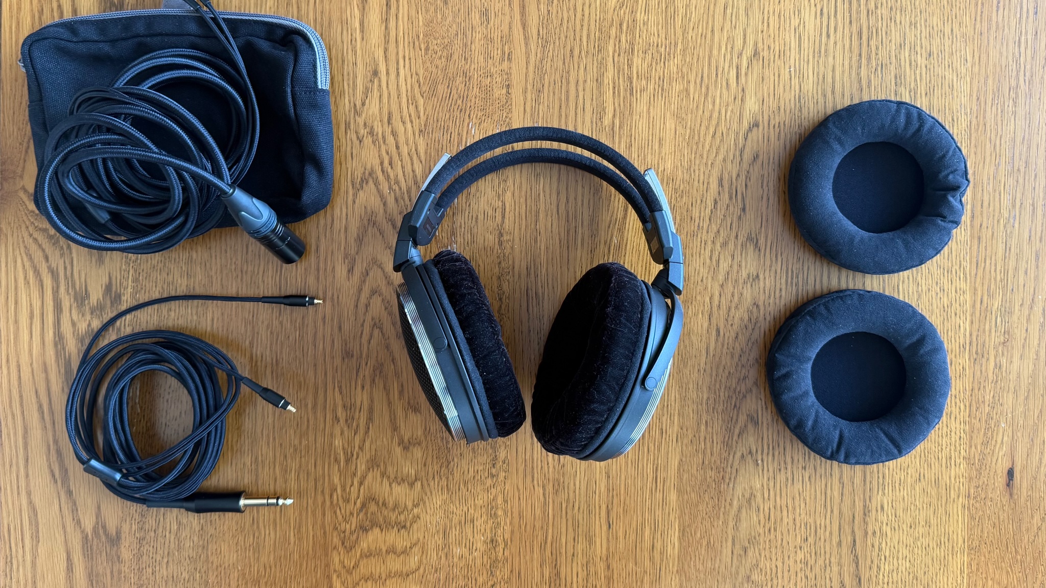 Photos of the Audio-Technica ATH-ADX7000 headphones on a wooden table
