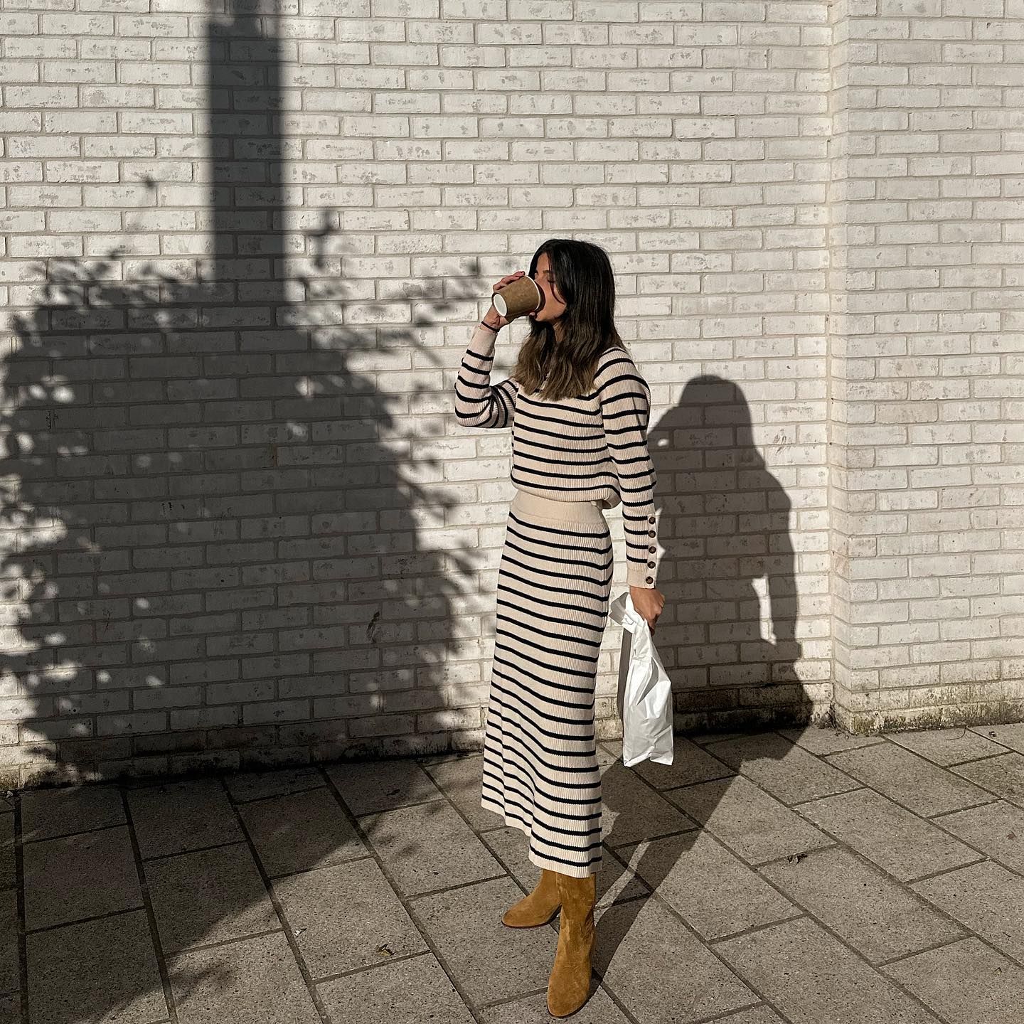 Influencer @_santinaharrison styles the suede boots trend.