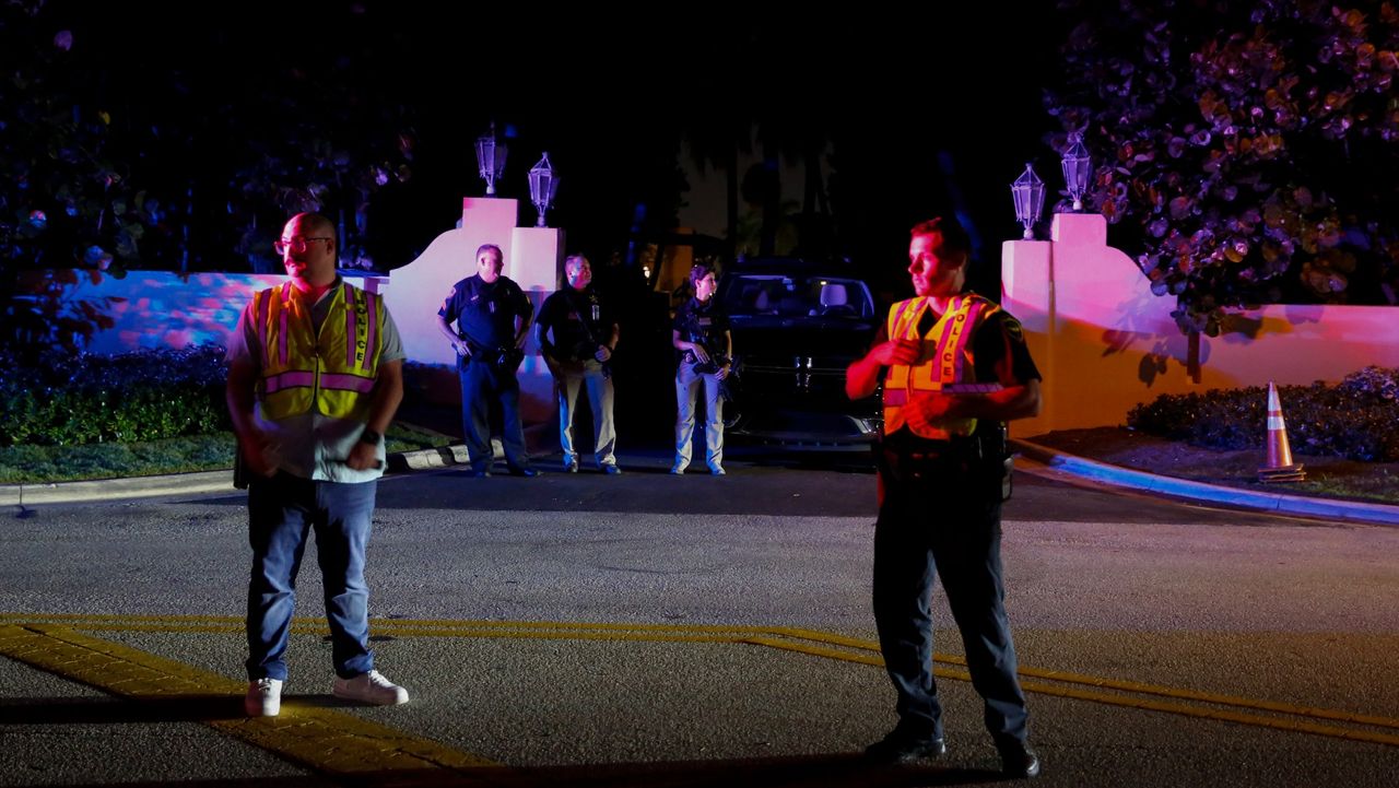 Police stand outside Donald Trump’s Mar-a-Lago estate on Monday