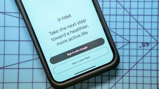 A screen in the Fitbit app asking if users want to sign in via Google or Fitbit account.