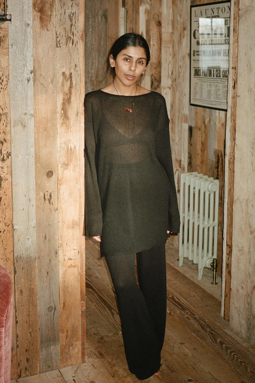 a woman wearing a green sheet boatneck top and matching pants