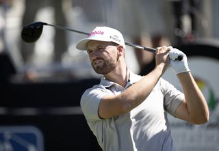 Wyndham Clark hits a drive and watches it in the air