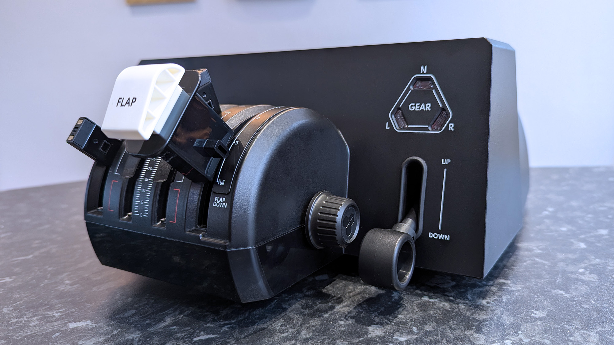 Honeycomb Aeronautical Bravo Throttle Quadrant Lite on a marble desk highlighting individual parts