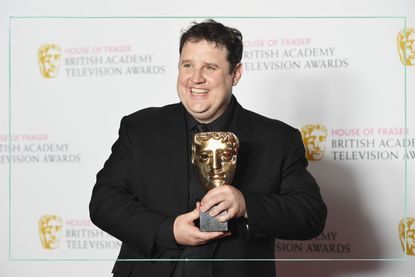 Peter Kay holding his award at the BAFTAs