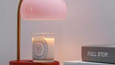 Wooden candle warmer with gold stem and pale pink glass shade