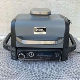 The Ninja Woodfire BBQ & Smoker being tested outside at home