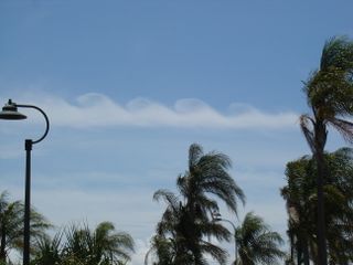 Kelvin-Helmholtz waves are the classic "surfer wave" pattern seen throughout nature where a fast fluid rushes over a slower-moving fluid. Here, Kelvin-Helmholtz waves appear in clouds.