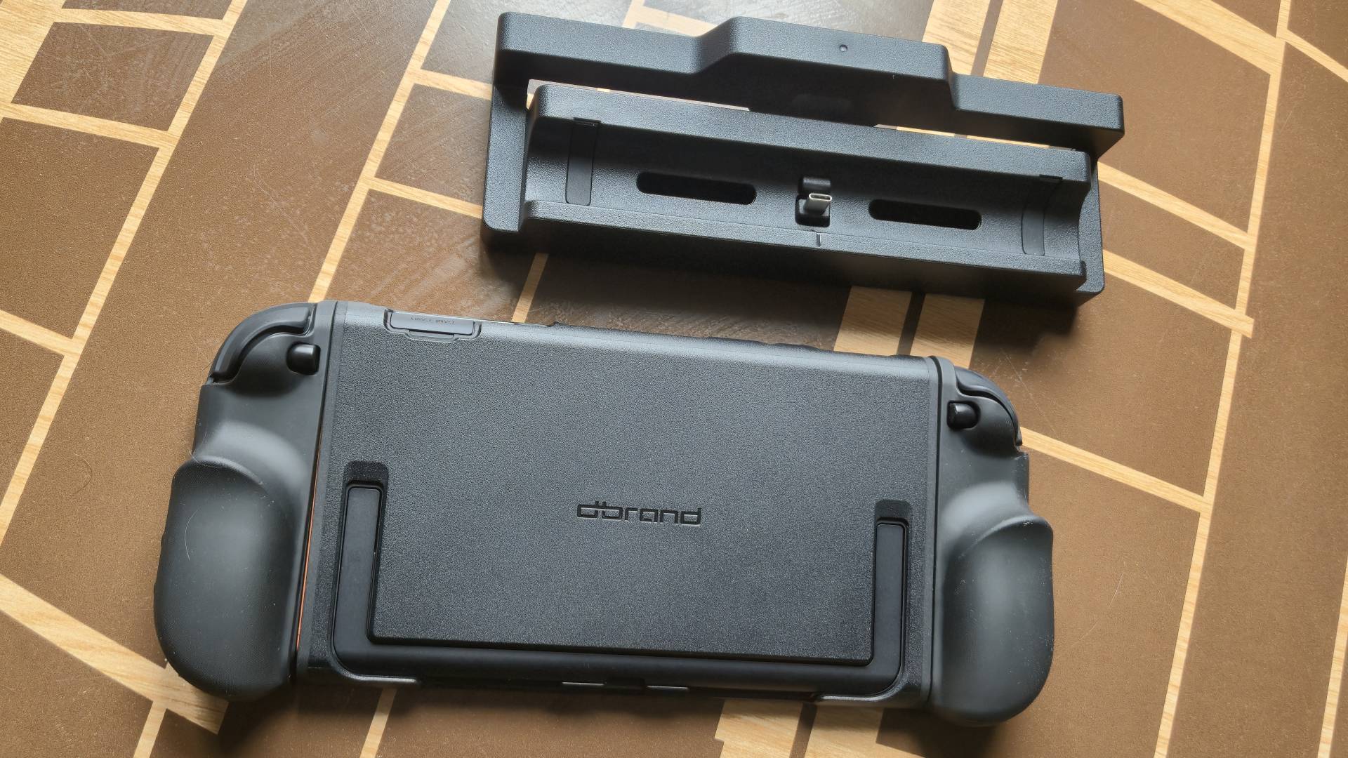 Photo by Rosalie Newcombe of the dbrand Killswitch case and its dock adapter.