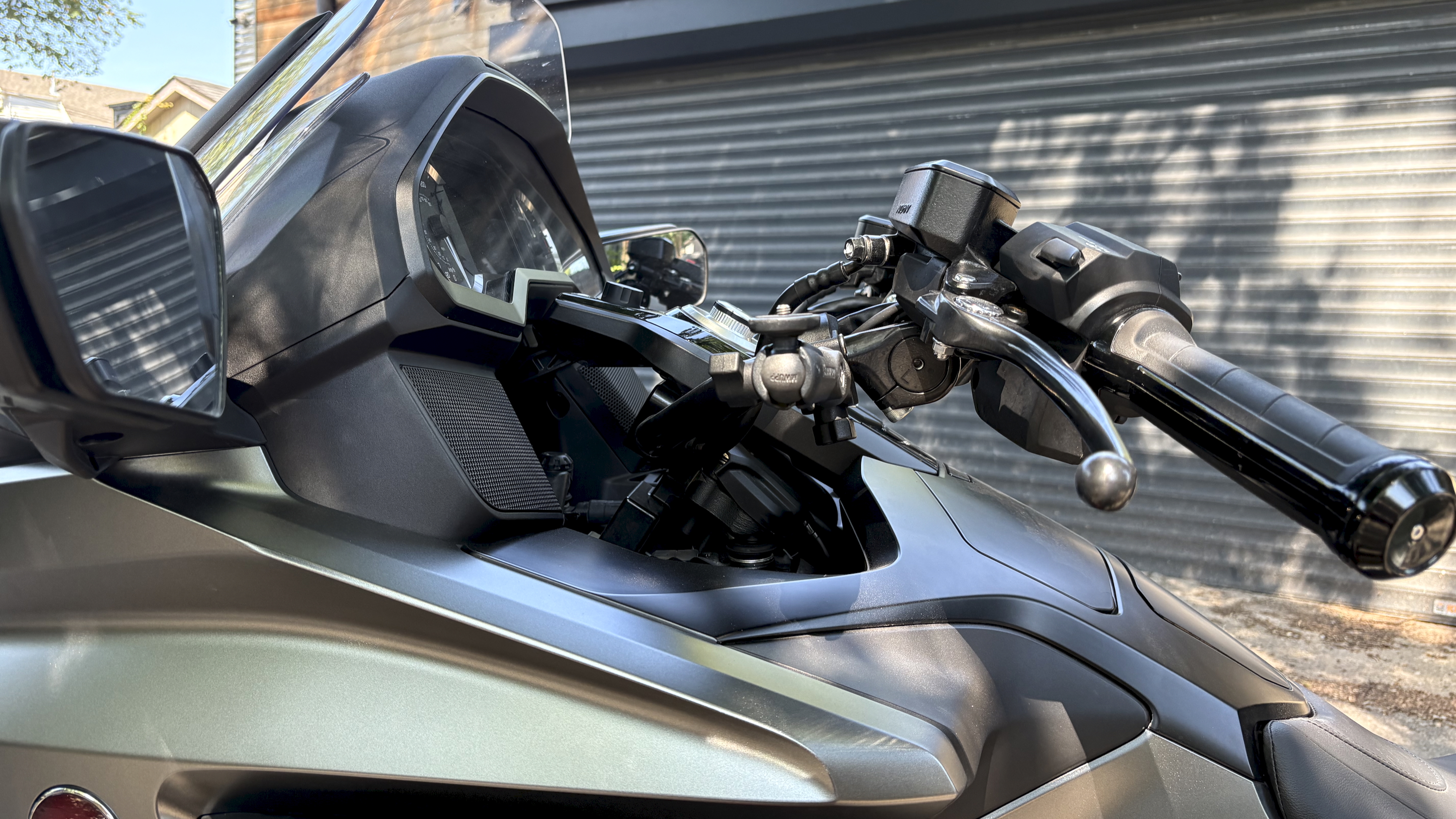 A Honda Goldwing touring motorbike, emphasising the sound system onboard, with a driver in a bike helmet