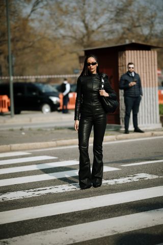 woman wearing leather jacket, leather pants, and boots