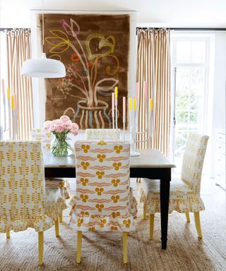 chocolate brown, pink and yellow dining room with loose cover upholstered chairs and stripe curtains