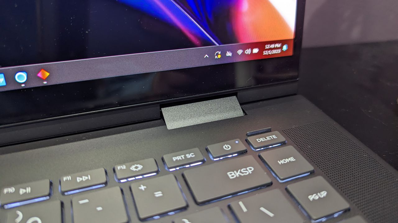 A close up of several keys on a laptop near the top right corner of the keyboard.