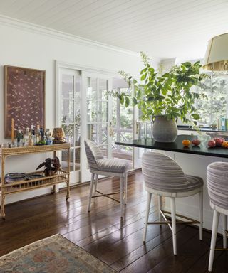 kitchen counter with bar stools and dark wood floor