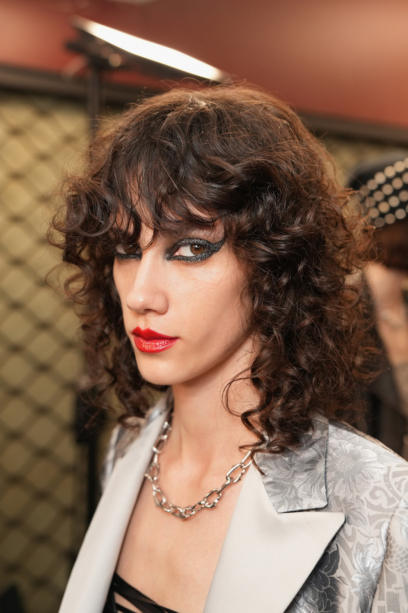 A model wearing their hair in a shag haircut.
