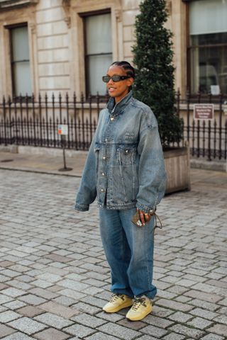 woman wearing denim jacket, baggy jeans, and sneakers