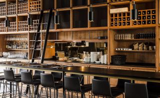 Campo Restaurant in Poland with black walls, table and chairs with wooden floors