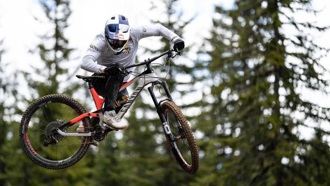 A Canyon rider in mid air, wearing a full face helmet