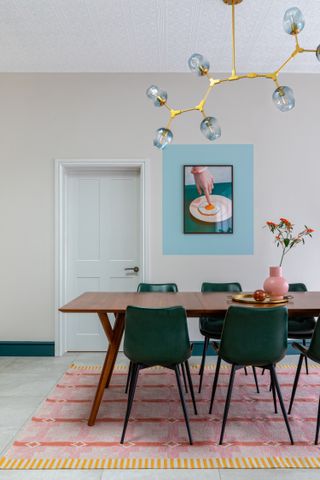 A dining room with dark green trim