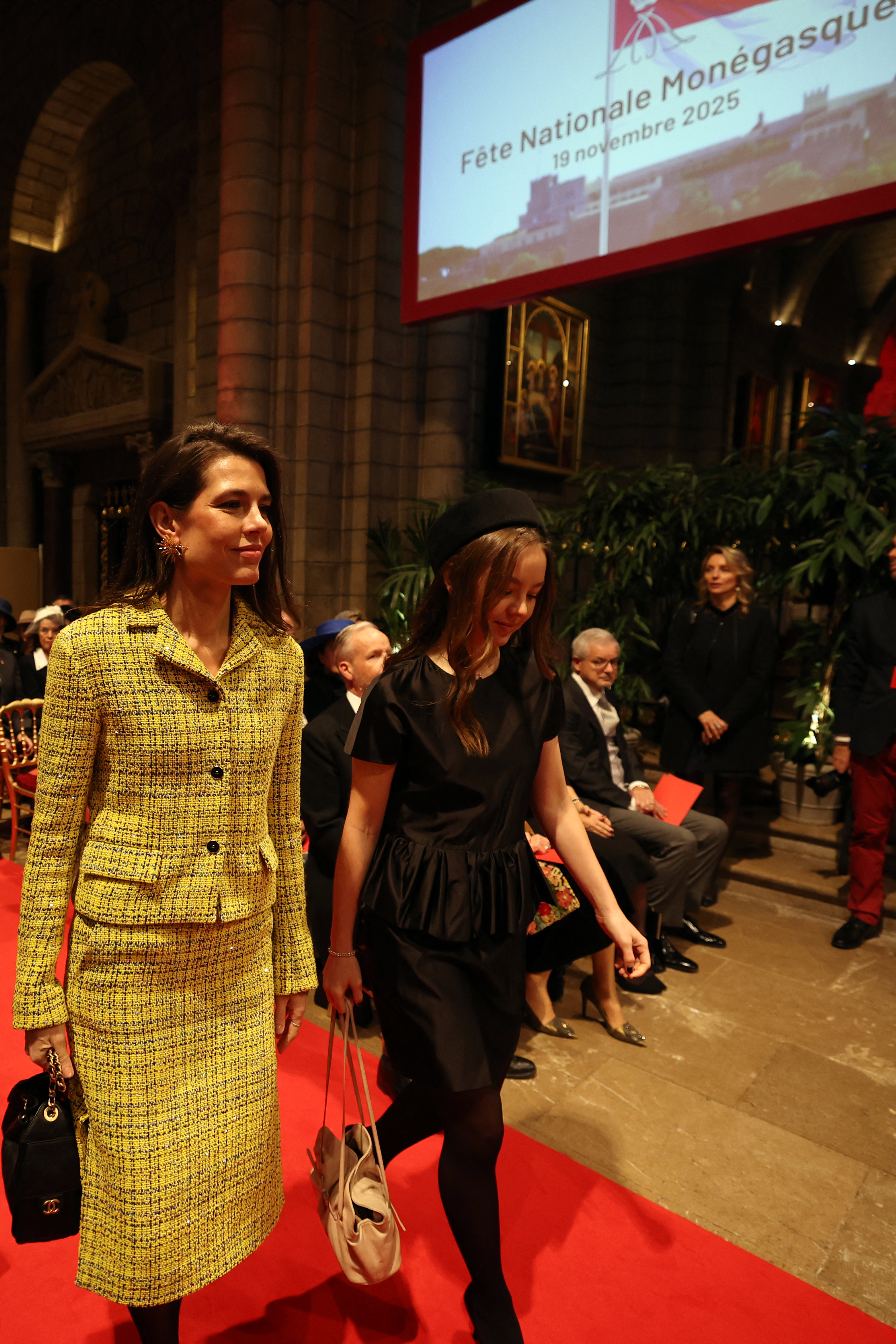 Charlotte Casiraghi in a yellow suit walking next to Charlotte of Hanover