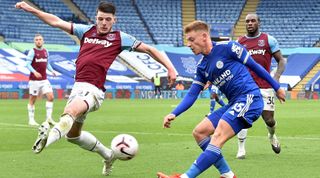 Harvey Barnes of Leicester City gets his cross in despite the close attention of Damian Rice of West Ham United