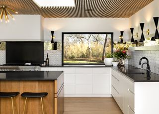 White and oak kitchen with black countertops