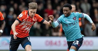 Burnley's Nathan Tella (right) competing with Luton Town's Reece Burke during the Sky Bet Championship between Luton Town and Burnley at Kenilworth Road on February 18, 2023 in Luton, United Kingdom.