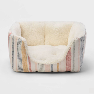 A striped pet bed with a fluffy lining
