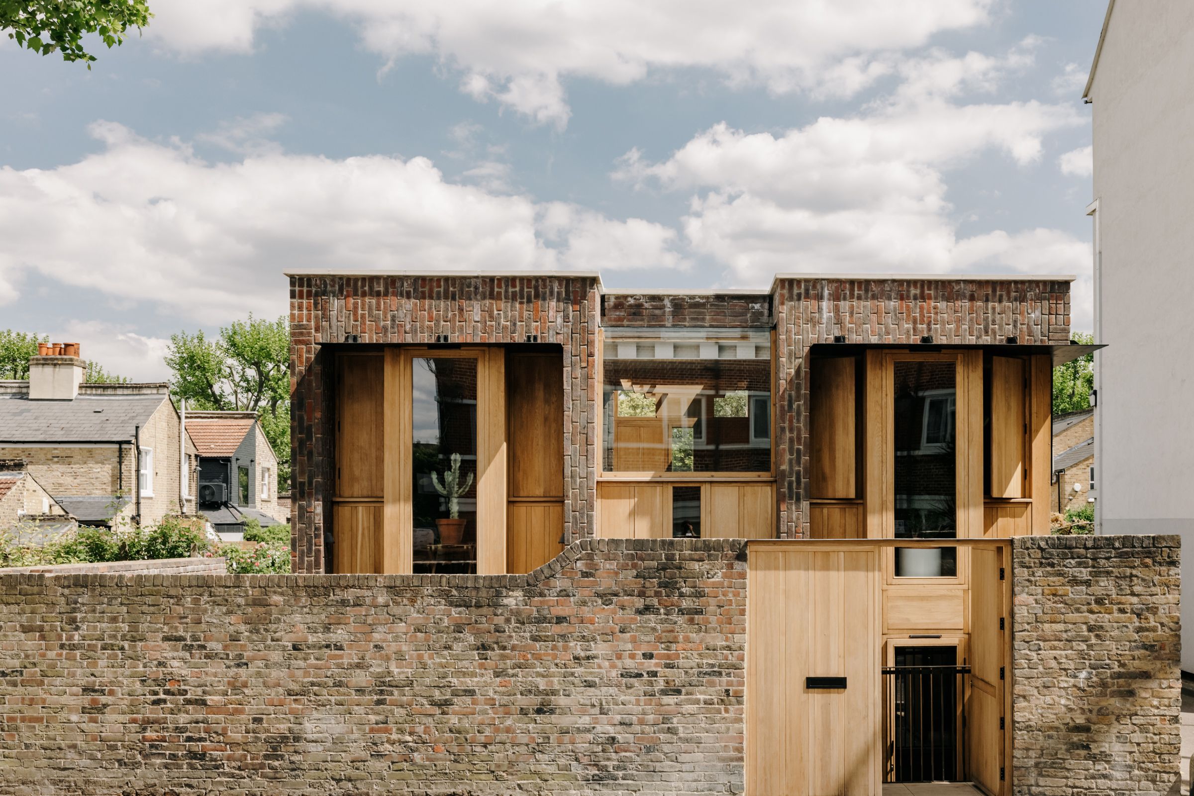 An intriguing new build that uses a palette of brick, oak, and steel ...