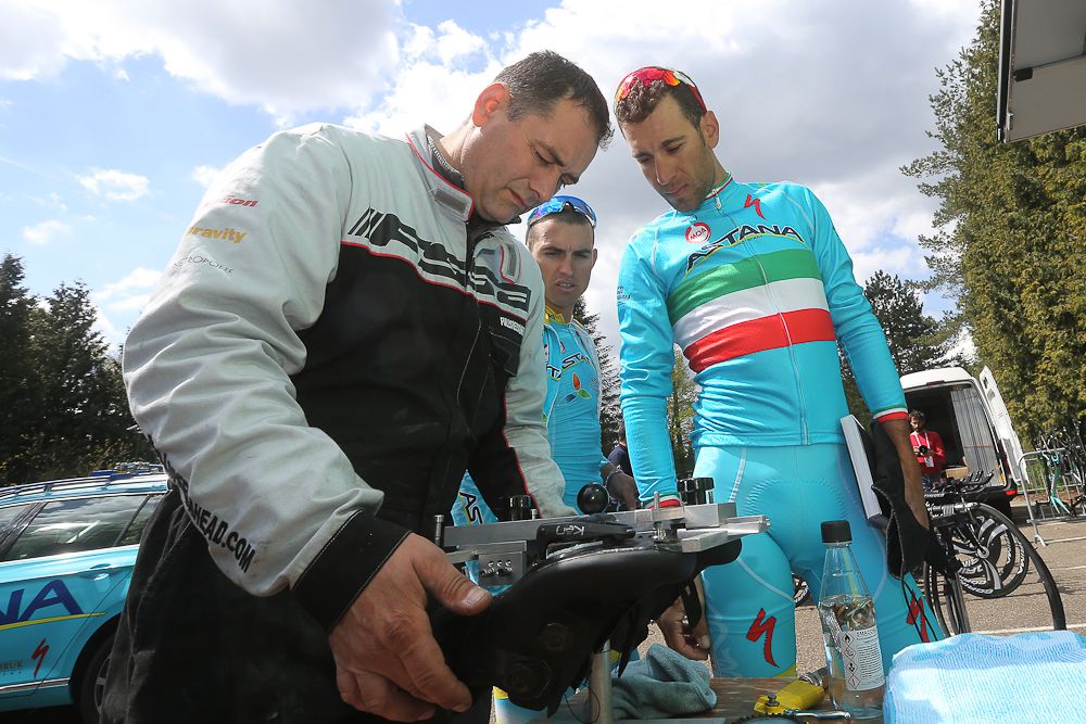 Vinncenzo Nibali watches a team mechanic work on a pair of shoes.