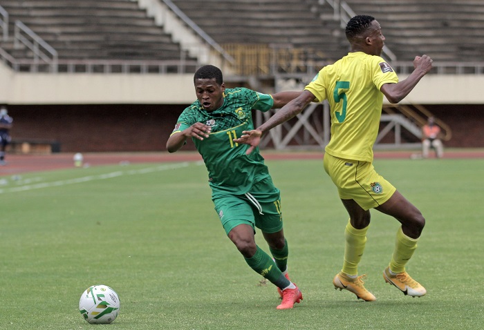 Luther Singh of South Africa goes past Divine Lunga of Zimbabwe during the Qatar 2022 FIFA World Cup qualifier between Zimbabwe and South Africa