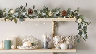 kitchen shelves with cups and fairy lights