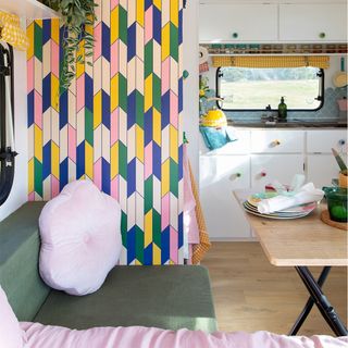 Caravan makeover with seating area and colourful wallpaper