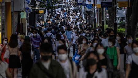 A busy street in Tokyo filled with people