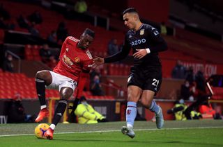 Manchester United’s Aaron Wan-Bissaka (left) and Aston Villa’s Anwar El Ghazi battle for the ball during the Premier League match at Old Trafford, Manchester