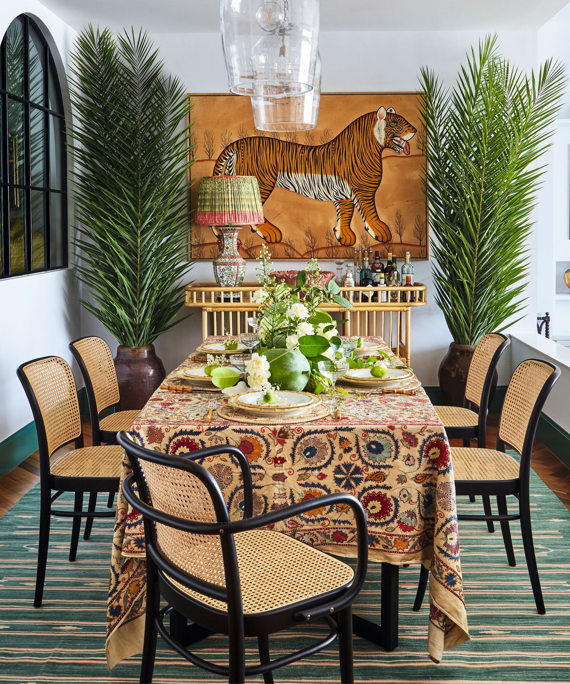 Orange tiger painting, glass light shades, black chair fames