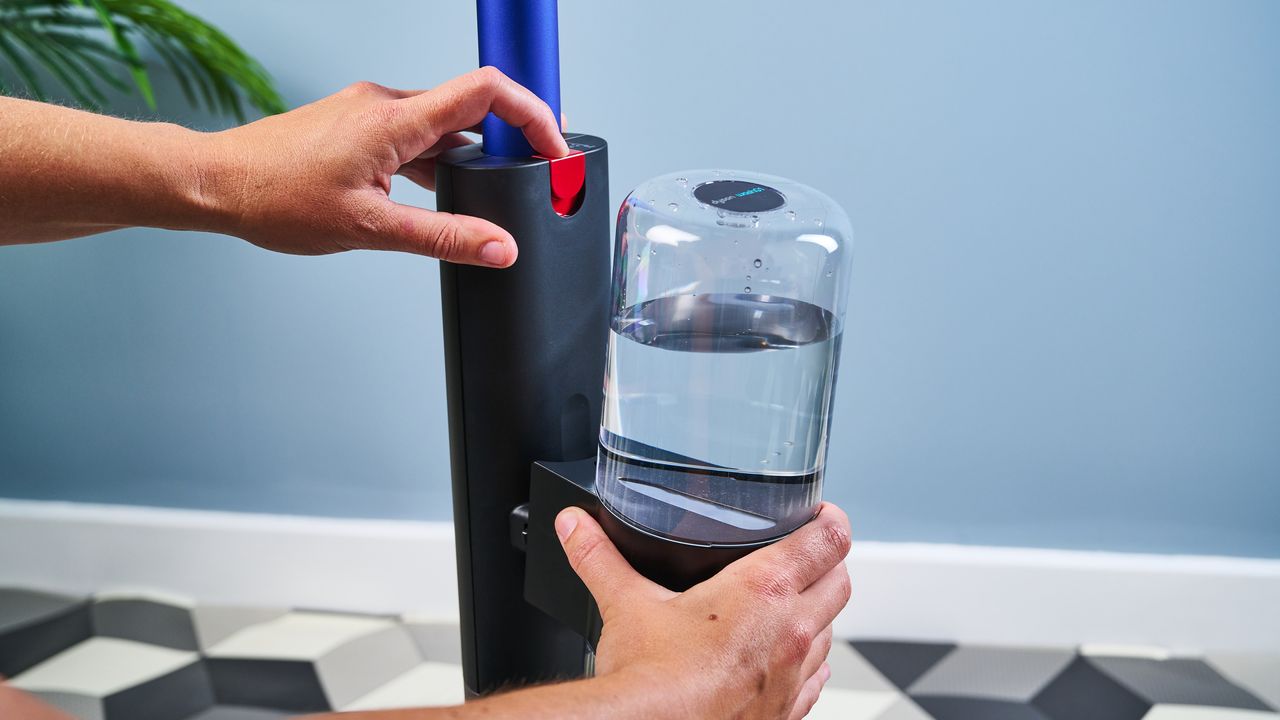 Water tanks being clipped onto Dyson WashG1 wet floor cleaner