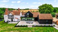 A 14th century listed home with a modern renovation and extension with black cladding