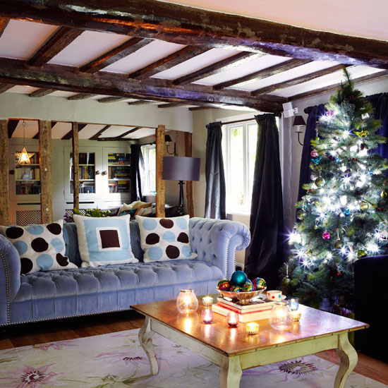 living area with wooden floor and christmas tree and sofa with cushions