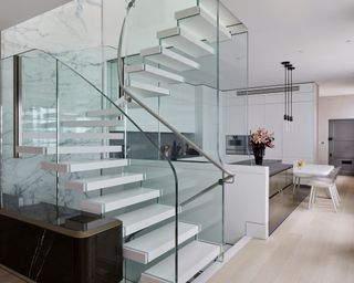 Silver leather stair railing idea with glass balustrade by Bisca =