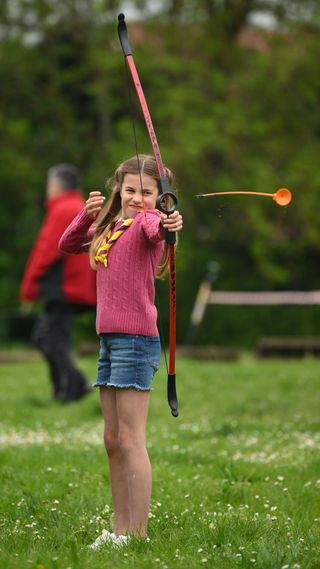 Princess Charlotte shooting a bow and arrow
