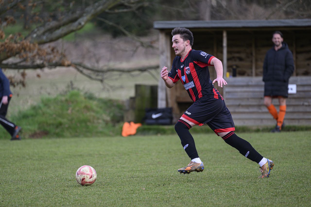 Some footballers playing in a field