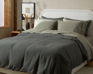 Percale Sheet Set in moss color in bedroom with biege walls and a white bed frame