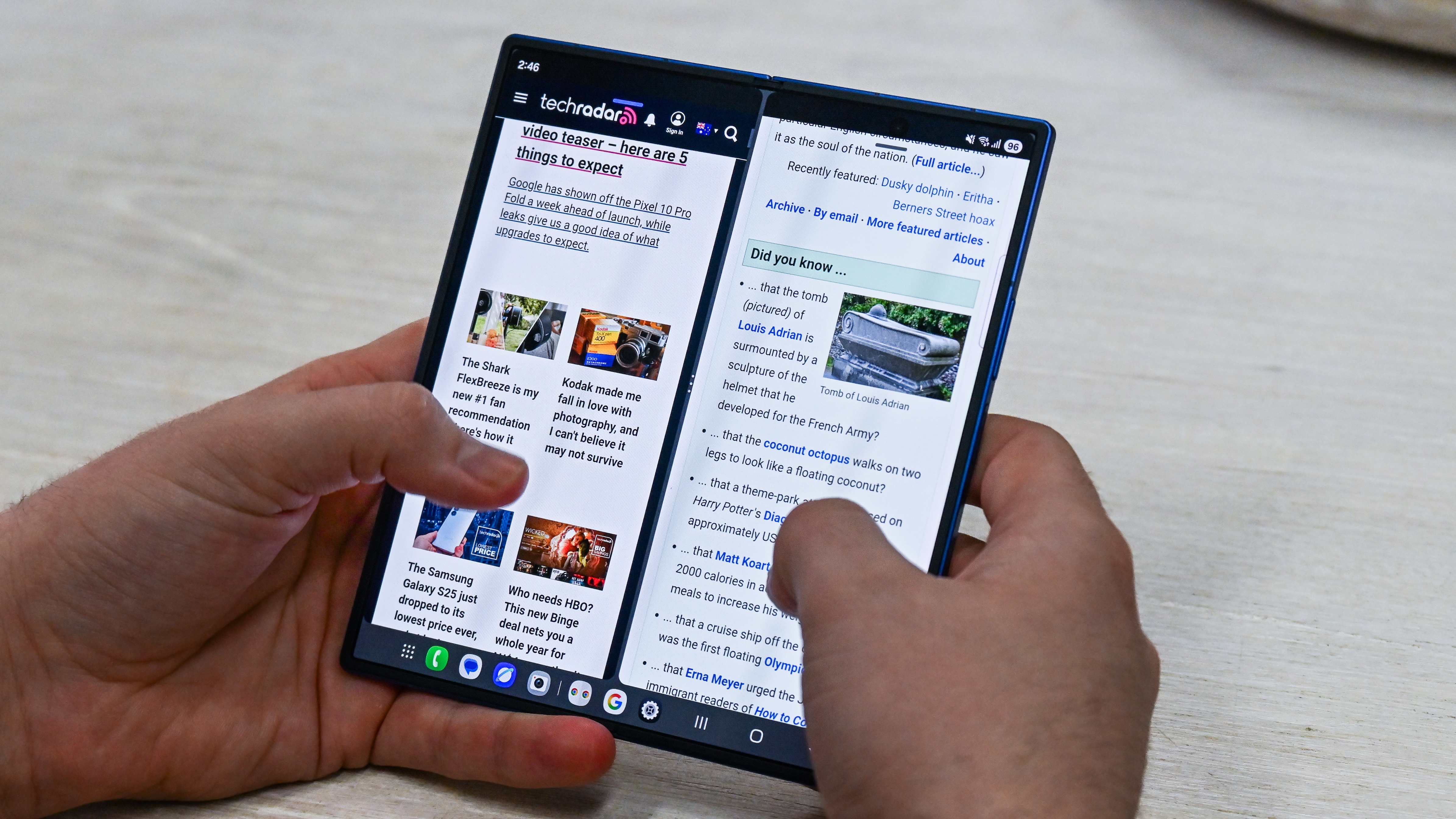 Someone using the Samsung Galaxy Z Fold 7 when unfolded, with two web browsers open at once.