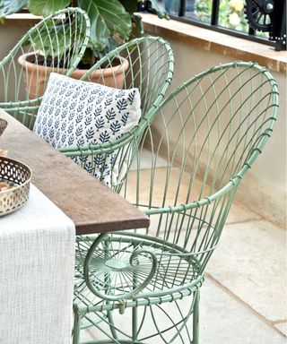 metal chairs and table in courtyard garden