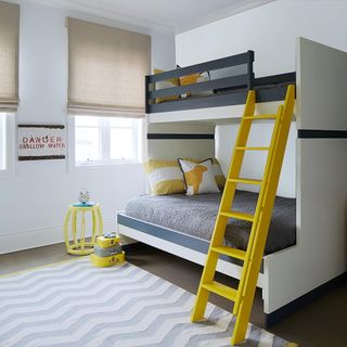 white bedroom with bunk bed and yellow ladder