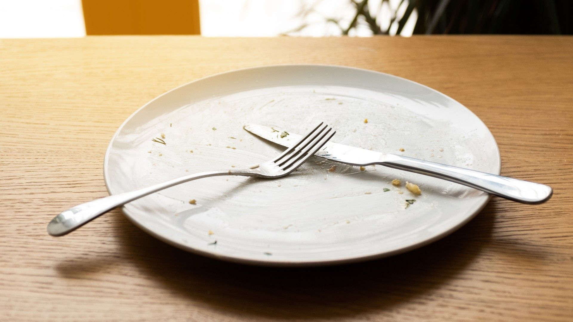 a dirty plate with a knife and fork