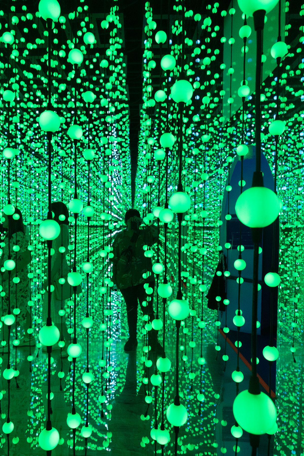 A photo of a woman standing amongst multiple lights taken on a Canon EOS R50 V mirrorless video camera